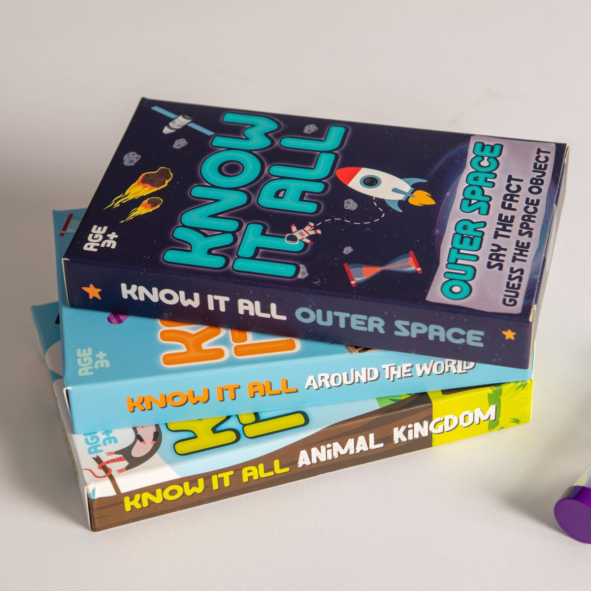 Know It All card game box stack: outer space, around the world, animal kingdom
