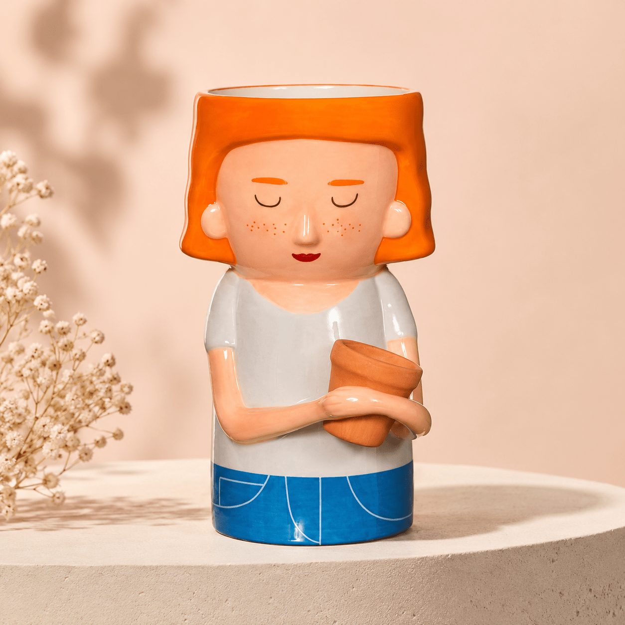 Red-haired lady ceramic plant pot vase with mini planter, holding a small pot
