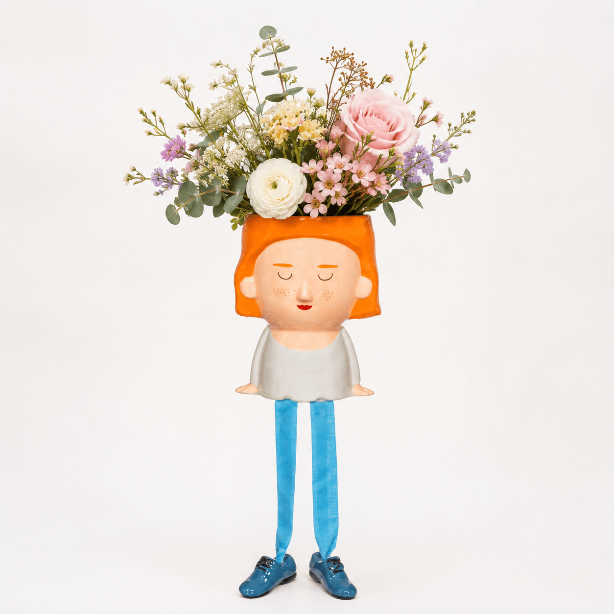 Orange-haired face planter with dangling legs and blue shoes holding a flower bouquet