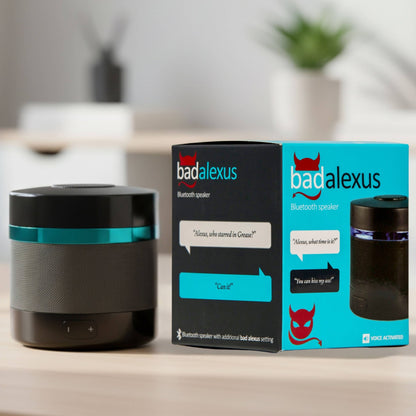 Black Bluetooth speaker with teal ring, beside speaker box