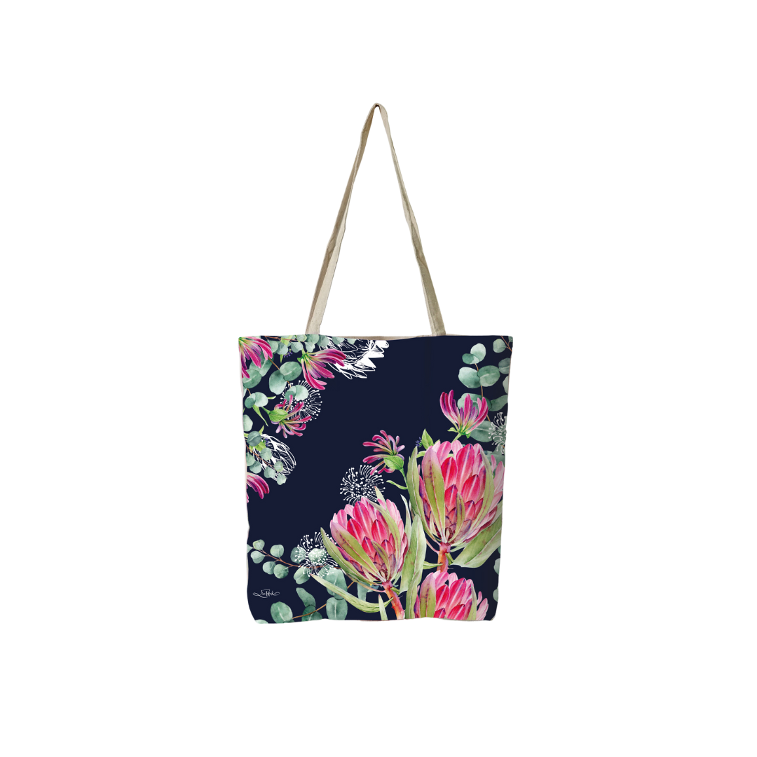 Navy reusable tote bag with pink tropical flowers and green foliage, long canvas handles
