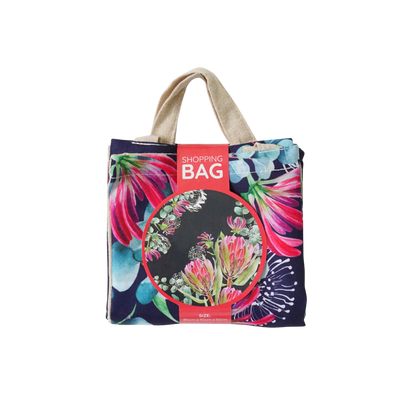 Navy shopping tote with pink flower print, short handles, red product label on front