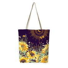 Reusable tote bag with purple floral sunflower design and butterfly accents, shoulder straps