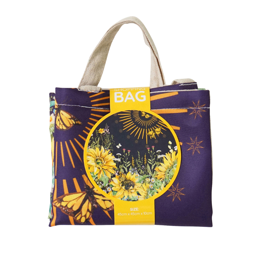 Reusable tote bag with purple field-floral print, round graphic and canvas handles