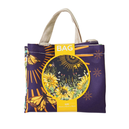 Reusable tote bag with purple field-floral print, round graphic and canvas handles