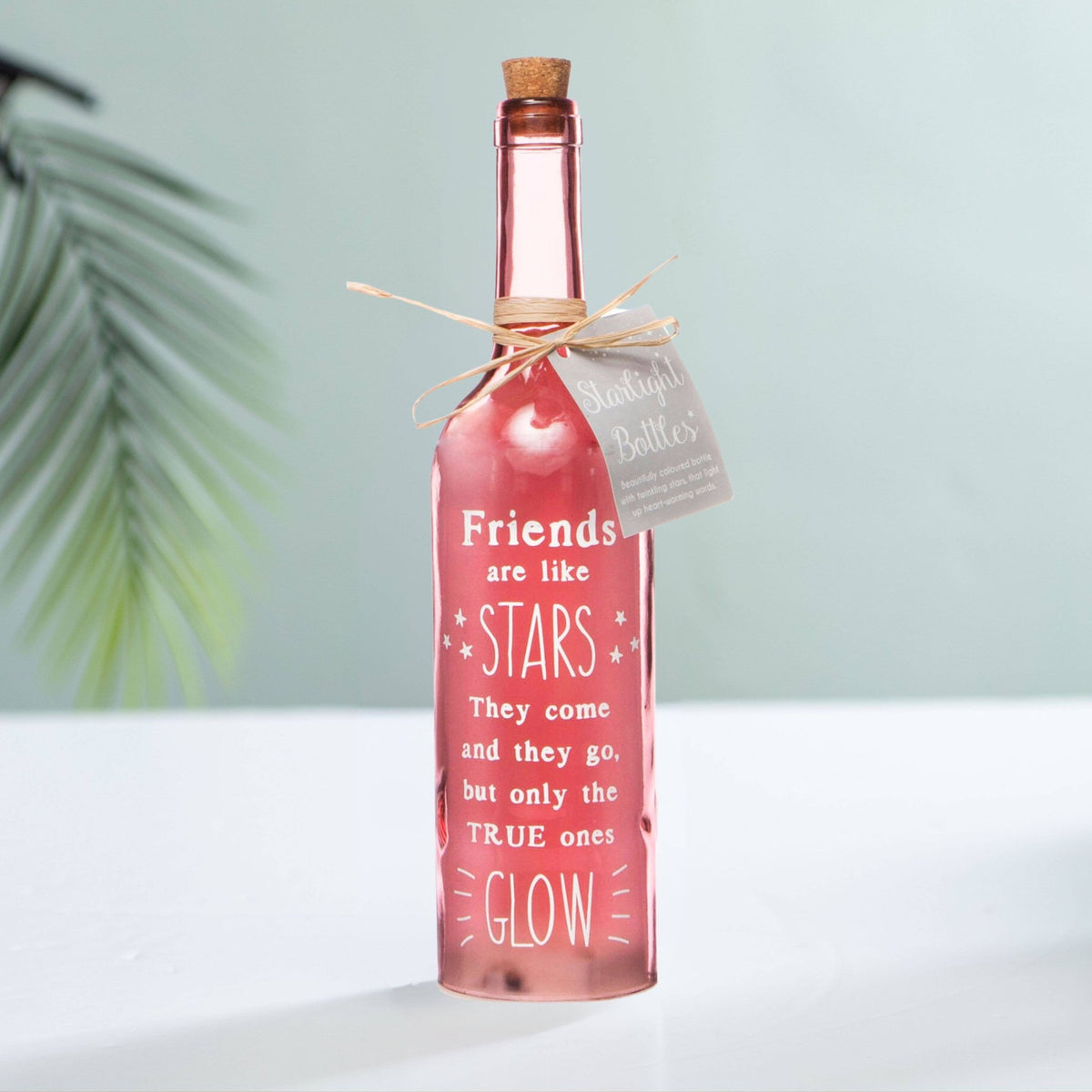 Pink starlight bottle with cork, starry friend message, and tied paper tag.