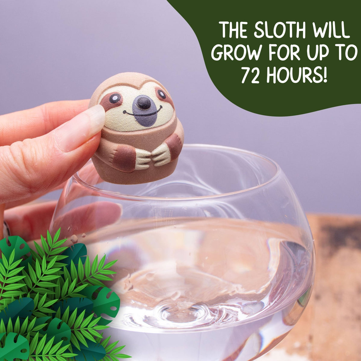 Hand holding an egg-shaped sloth toy above a clear water-filled container