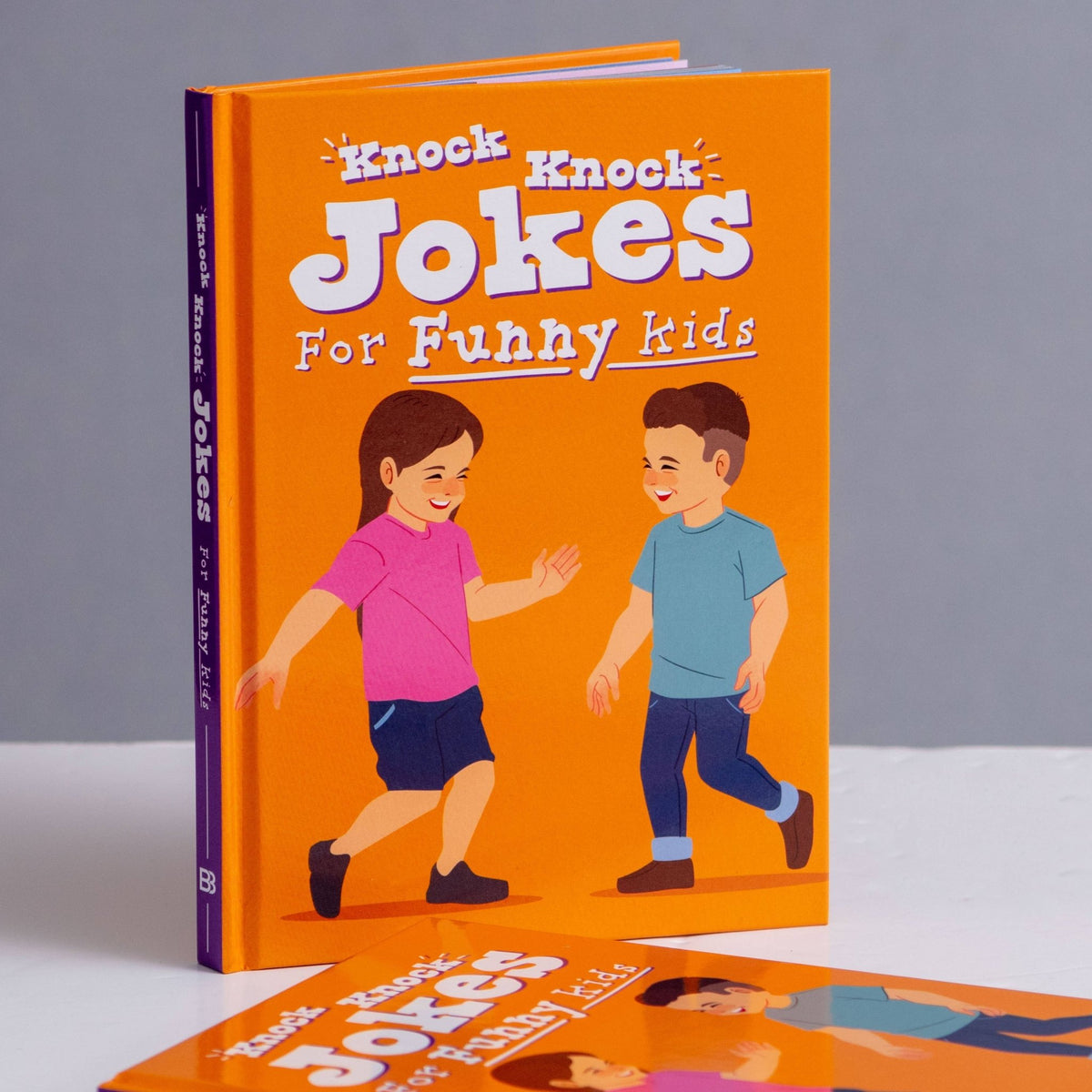 Children's knock-knock joke book with orange cover and cartoon kids, hardback