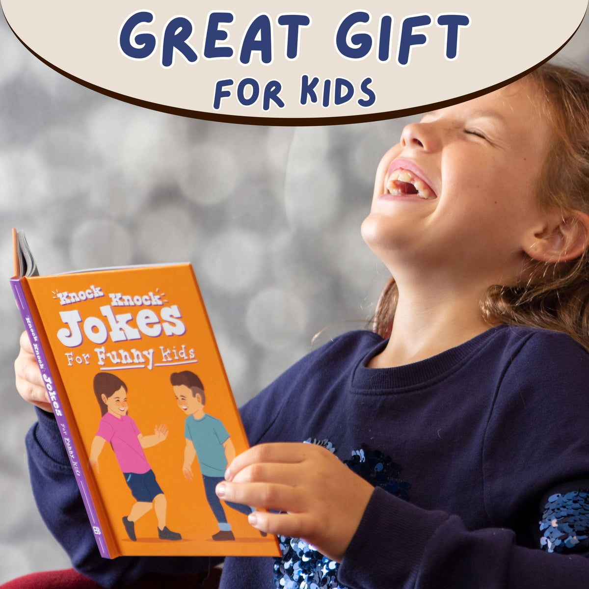 Kids knock-knock joke book held by a child, orange cover with cartoon kids