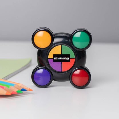 Mini Memory Match game with four colored lights and a rotating center disk, black base