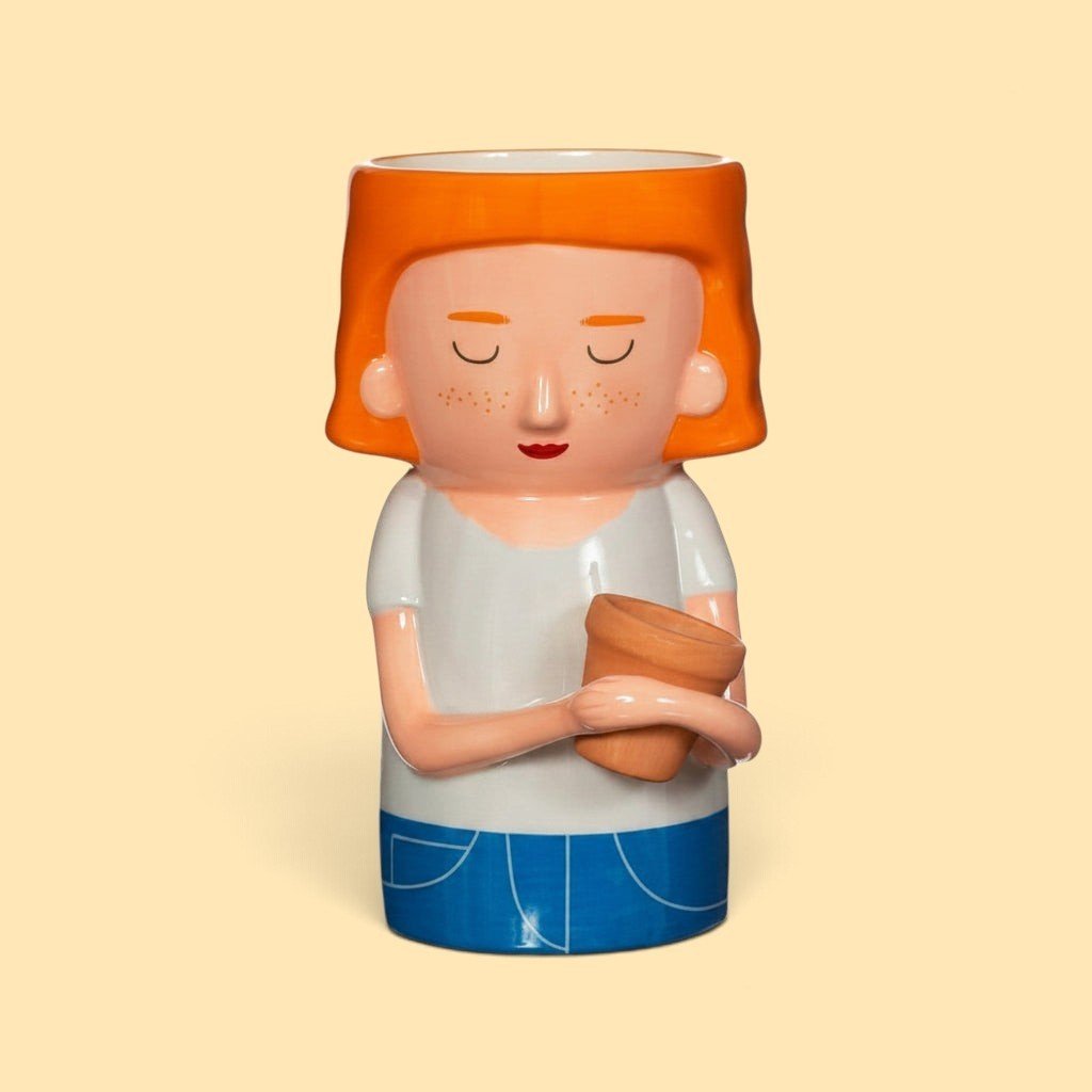 Quirky Turkey Gifts dolomite vase shaped like a red-haired woman in a white t-shirt holding a mini terracotta planter