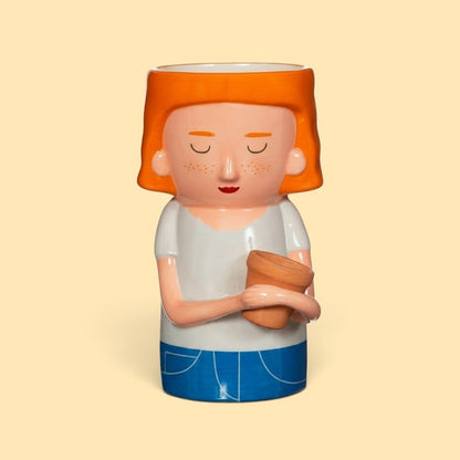 Quirky Turkey Gifts dolomite vase shaped like a red-haired woman in a white t-shirt holding a mini terracotta planter