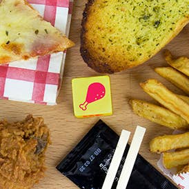 Takeaway dice, small yellow cube with red fast-food symbols