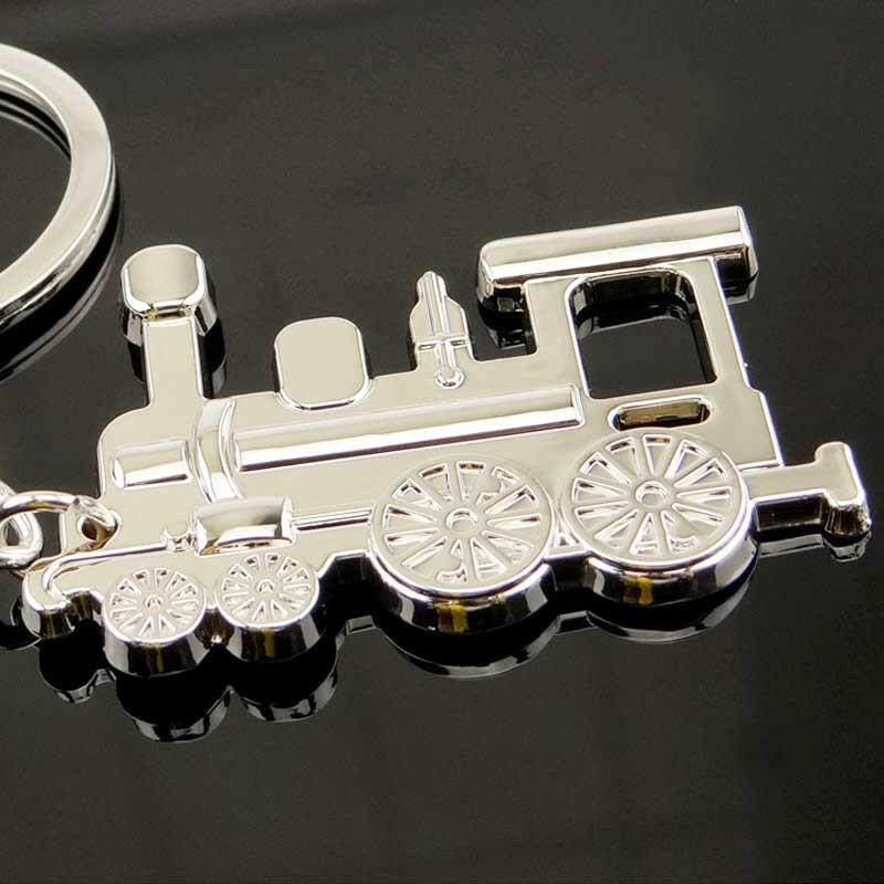 Silver train locomotive keyring charm with front cab and wheel details, close-up