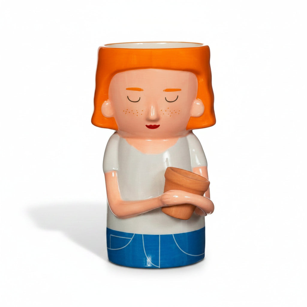 Plant mum planter face with orange hair and closed eyes, holding a terracotta pot
