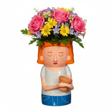 Plant mum planter with orange hair and closed eyes, holding a terracotta pot front view
